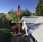 LED Commercial Telescoping Flagpole Kit 1 - installed, flagpole lighting system illuminating american flag at residential